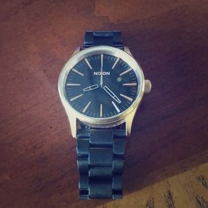 Gold and black Nixon watch
